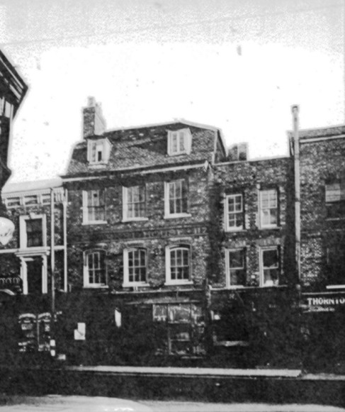 view showing 3 storey brick built properties on a spring day