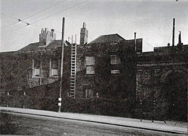 view showing two 2-storey brick built properties adjoining an archway to the right of no. 78