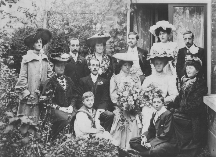 Wedding group in back garden, beautiful hats