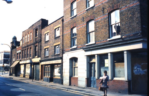 Row of dilapidated 3 storey brick buildings